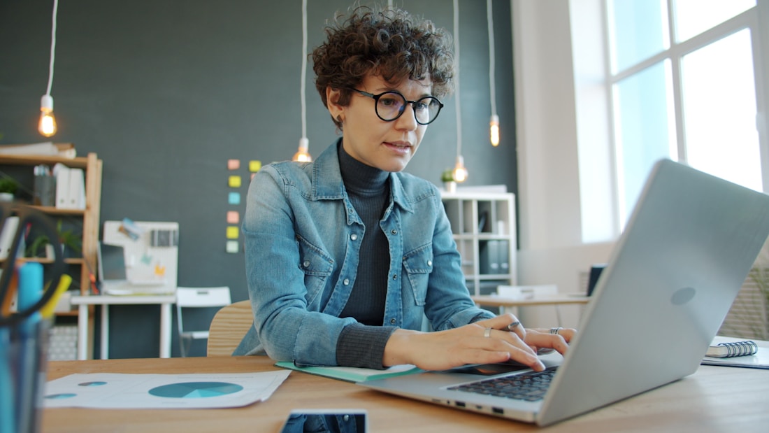 Agency administrator working in the system on her laptop